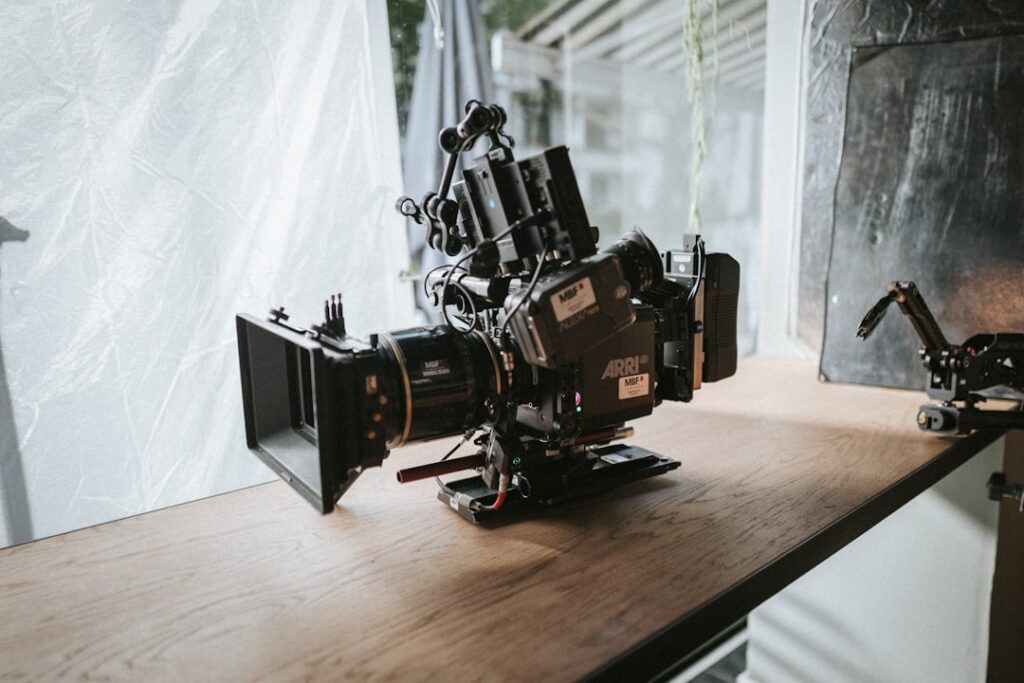 black-video-camera-on-wooden-surface-cnttzlorl9s
